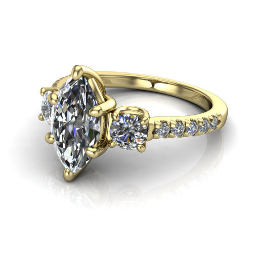 Celeste marquise three stone engagement ring in 14K Yellow Gold, three-quarter perspective showing the center diamond between two round side stones above a pav&eacute; shank