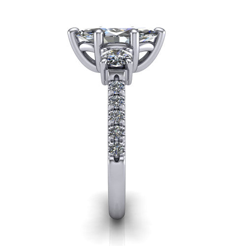 Celeste marquise three stone engagement ring in Platinum, side profile showing the round side stone and the pav&eacute; diamonds running down the shank