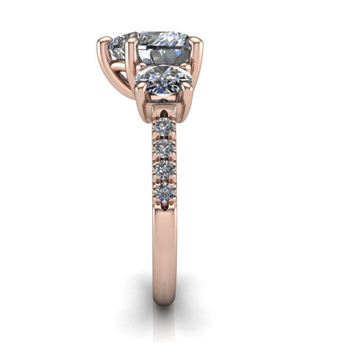 Celeste heart three stone engagement ring in 14K Rose Gold, side profile showing the round side stone and the pav&eacute; diamonds running down the shank