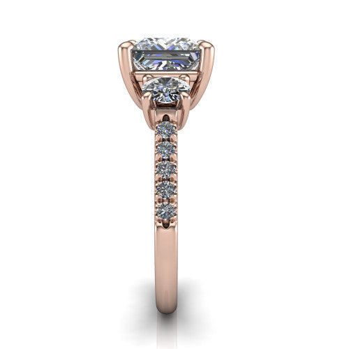 Celeste princess three stone engagement ring in 14K Rose Gold, side profile showing the round side stone and the pav&eacute; diamonds running down the shank