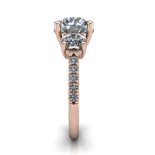 Celeste round three stone engagement ring in 14K Rose Gold, side profile showing the round side stone and the pav&eacute; diamonds running down the shank