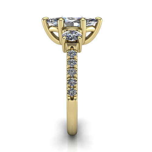 Celeste marquise three stone engagement ring in 14K Yellow Gold, side profile showing the round side stone and the pav&eacute; diamonds running down the shank