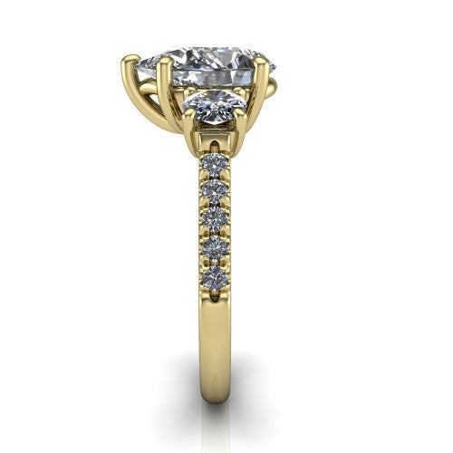 Celeste pear three stone engagement ring in 14K Yellow Gold, side profile showing the round side stone and the pav&eacute; diamonds running down the shank