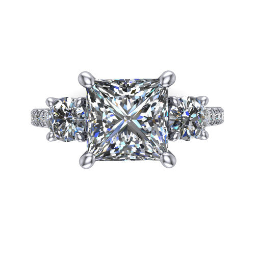 Celeste princess three stone engagement ring in Platinum, top-down view showing the center diamond flanked by two round side stones in a classic three stone setting