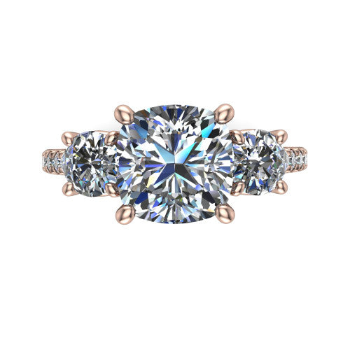 Celeste cushion three stone engagement ring in 18K Rose Gold, top-down view showing the center diamond flanked by two round side stones in a classic three stone setting