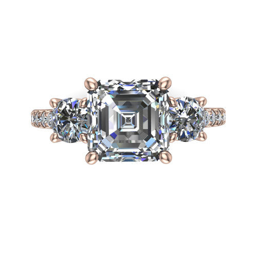 Celeste asscher three stone engagement ring in 18K Rose Gold, top-down view showing the center diamond flanked by two round side stones in a classic three stone setting