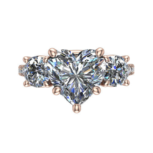 Celeste heart three stone engagement ring in 18K Rose Gold, top-down view showing the center diamond flanked by two round side stones in a classic three stone setting