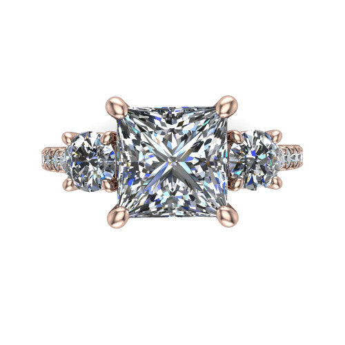 Celeste princess three stone engagement ring in 18K Rose Gold, top-down view showing the center diamond flanked by two round side stones in a classic three stone setting