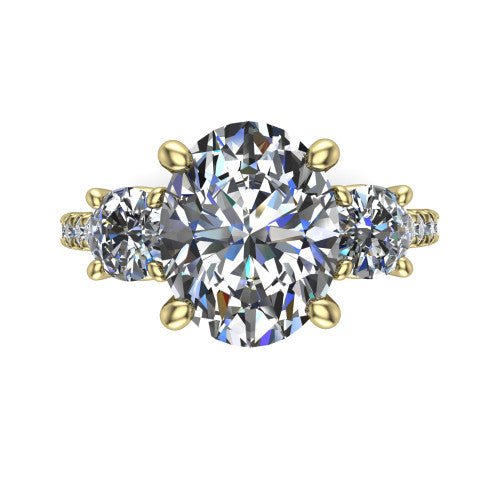 Celeste oval three stone engagement ring in 18K Yellow Gold, top-down view showing the center diamond flanked by two round side stones in a classic three stone setting