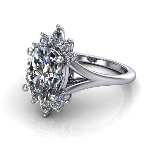 Sage oval halo engagement ring in 18K White Gold, three-quarter perspective showing the center framed by a vintage cluster halo of pear and round diamonds above a split shank