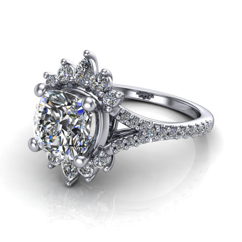 Sienna cushion halo engagement ring in Platinum, three-quarter perspective showing the center framed by a vintage cluster halo of pear and round diamonds above a pav&eacute; split shank