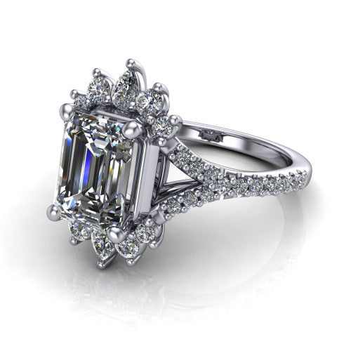 Sienna emerald halo engagement ring in Platinum, three-quarter perspective showing the center framed by a vintage cluster halo of pear and round diamonds above a pav&eacute; split shank