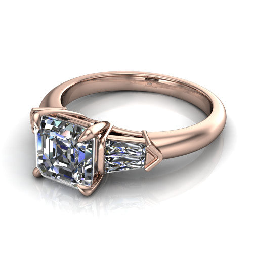 Gracie square emerald three stone engagement ring in 18K Rose Gold, three-quarter perspective showing the square emerald center diamond between tapered baguette side stones