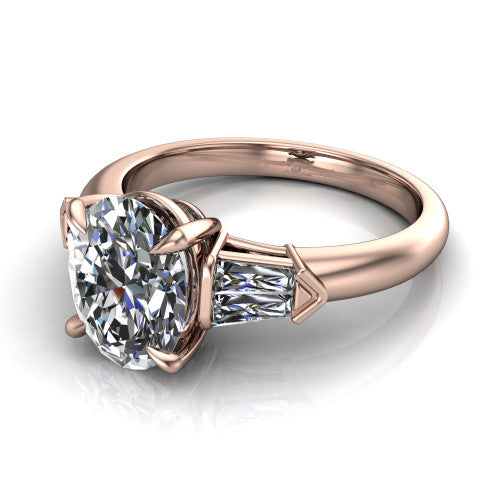 Gracie oval three stone engagement ring in 18K Rose Gold, three-quarter perspective showing the oval center diamond between tapered baguette side stones