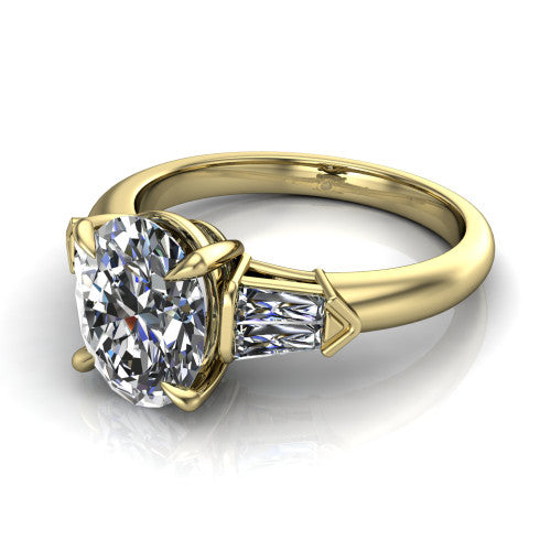 Gracie oval three stone engagement ring in 14K Yellow Gold, three-quarter perspective showing the oval center diamond between tapered baguette side stones