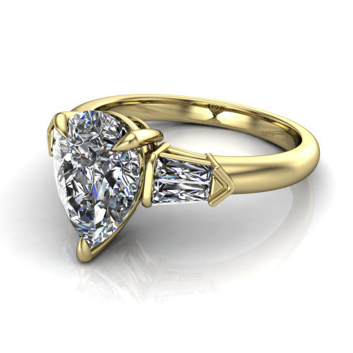Gracie pear three stone engagement ring in 18K Yellow Gold, three-quarter perspective showing the pear center diamond between tapered baguette side stones
