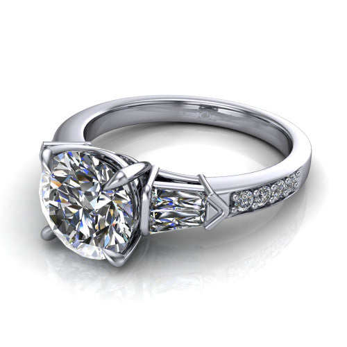 Audrey round three stone engagement ring in Platinum, three-quarter perspective showing the center diamond between two tapered baguette side stones above a pav&eacute; band