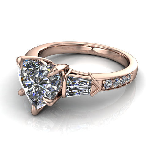 Audrey heart three stone engagement ring in 14K Rose Gold, three-quarter perspective showing the center diamond between two tapered baguette side stones above a pav&eacute; band