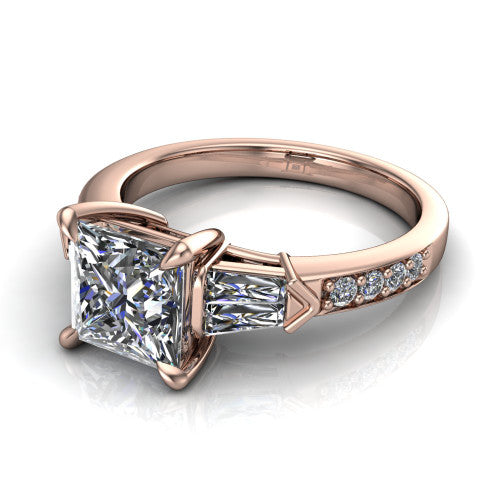 Audrey princess three stone engagement ring in 18K Rose Gold, three-quarter perspective showing the center diamond between two tapered baguette side stones above a pav&eacute; band