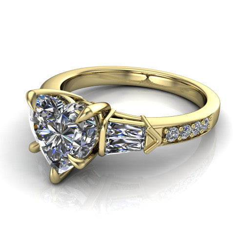 Audrey heart three stone engagement ring in 18K Yellow Gold, three-quarter perspective showing the center diamond between two tapered baguette side stones above a pav&eacute; band