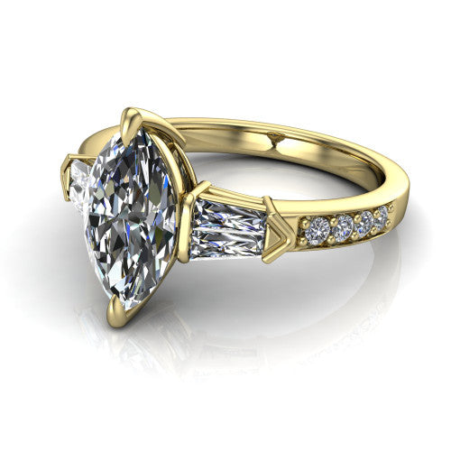 Audrey marquise three stone engagement ring in 18K Yellow Gold, three-quarter perspective showing the center diamond between two tapered baguette side stones above a pav&eacute; band