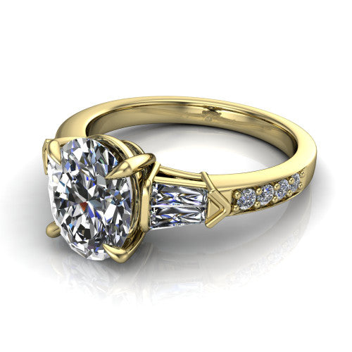 Audrey oval three stone engagement ring in 14K Yellow Gold, three-quarter perspective showing the center diamond between two tapered baguette side stones above a pav&eacute; band