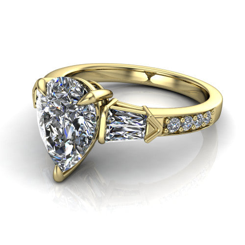 Audrey pear three stone engagement ring in 18K Yellow Gold, three-quarter perspective showing the center diamond between two tapered baguette side stones above a pav&eacute; band