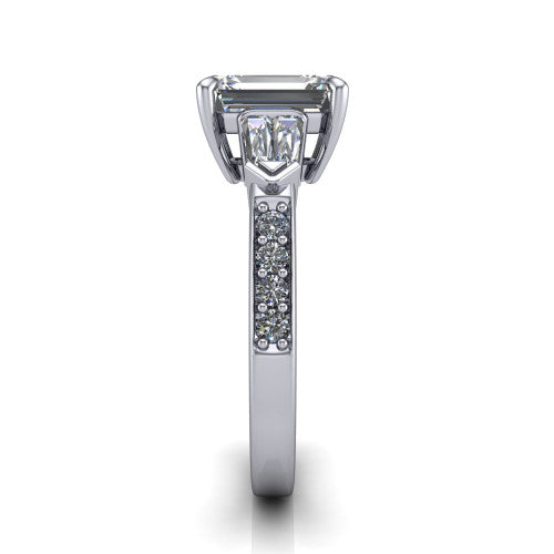 Audrey emerald three stone engagement ring in 14K White Gold, side profile showing the tapered baguette side stone and the round diamonds running down the shank