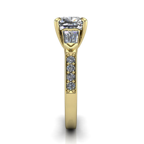 Audrey cushion three stone engagement ring in 18K Yellow Gold, side profile showing the tapered baguette side stone and the round diamonds running down the shank
