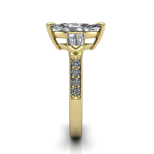 Audrey marquise three stone engagement ring in 18K Yellow Gold, side profile showing the tapered baguette side stone and the round diamonds running down the shank