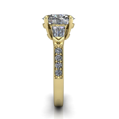 Audrey oval three stone engagement ring in 14K Yellow Gold, side profile showing the tapered baguette side stone and the round diamonds running down the shank