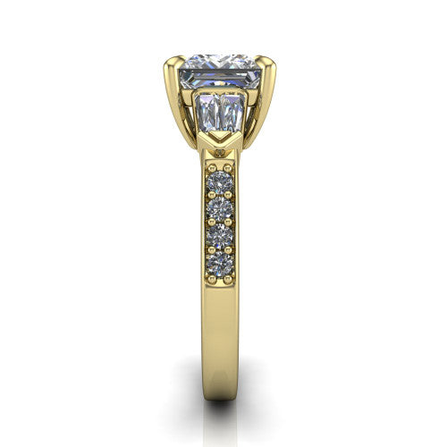Audrey princess three stone engagement ring in 14K Yellow Gold, side profile showing the tapered baguette side stone and the round diamonds running down the shank