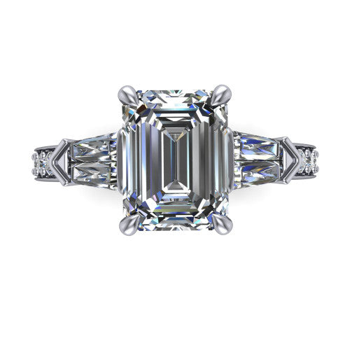 Audrey emerald three stone engagement ring in Platinum, top-down view showing the center diamond flanked by two tapered baguette side stones over a diamond-set shank
