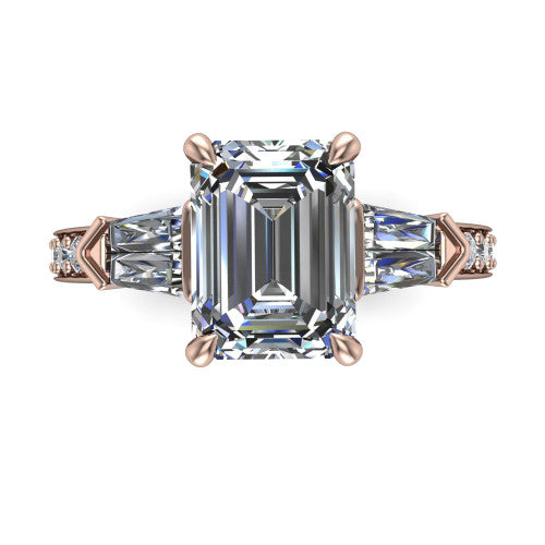 Audrey emerald three stone engagement ring in 18K Rose Gold, top-down view showing the center diamond flanked by two tapered baguette side stones over a diamond-set shank