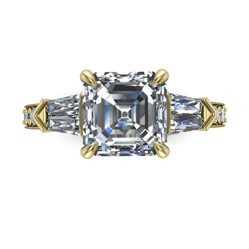 Audrey asscher three stone engagement ring in 18K Yellow Gold, top-down view showing the center diamond flanked by two tapered baguette side stones over a diamond-set shank