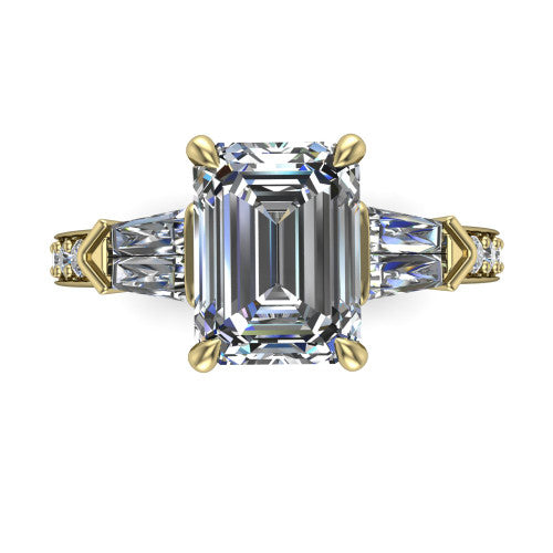 Audrey emerald three stone engagement ring in 14K Yellow Gold, top-down view showing the center diamond flanked by two tapered baguette side stones over a diamond-set shank