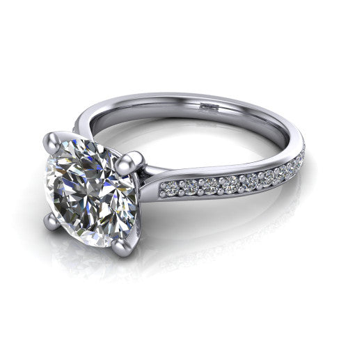 Ruby round classic engagement ring in 18K White Gold, three-quarter perspective showing the solitaire center diamond raised above a pav&eacute; shank