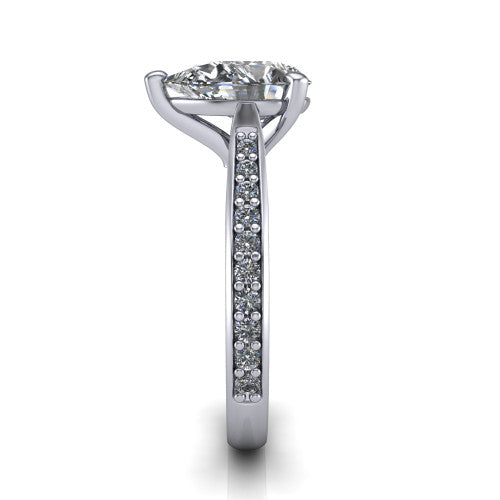 Ruby pear classic engagement ring in Platinum, side profile showing the cathedral shoulders and the round diamonds running down the shank