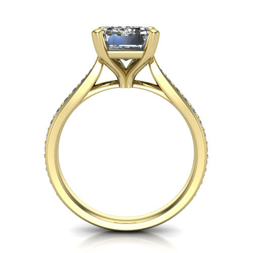 Ruby emerald classic engagement ring in 18K Yellow Gold, through-finger front profile showing the solitaire head raised above the pav&eacute; band and trellis gallery