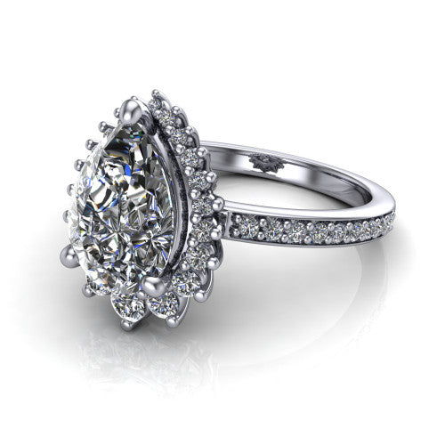 Persephone pear halo engagement ring in Platinum, three-quarter perspective showing the center framed by a vintage starburst cluster halo above a pav&eacute; shank