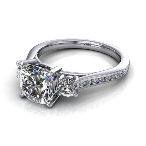 Saoirse cushion three stone engagement ring in 18K White Gold, three-quarter perspective showing the center diamond between two round side stones above a pav&eacute; shank