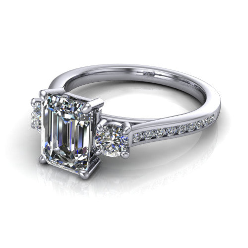 Saoirse emerald three stone engagement ring in 14K White Gold, three-quarter perspective showing the center diamond between two round side stones above a pav&eacute; shank
