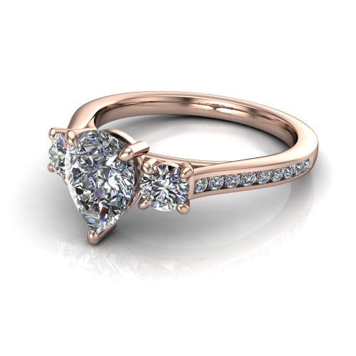 Saoirse pear three stone engagement ring in 14K Rose Gold, three-quarter perspective showing the center diamond between two round side stones above a pav&eacute; shank