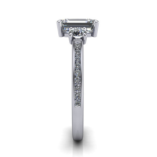 Saoirse emerald three stone engagement ring in 18K White Gold, side profile showing the round side stone and the pav&eacute; diamonds running down the shank