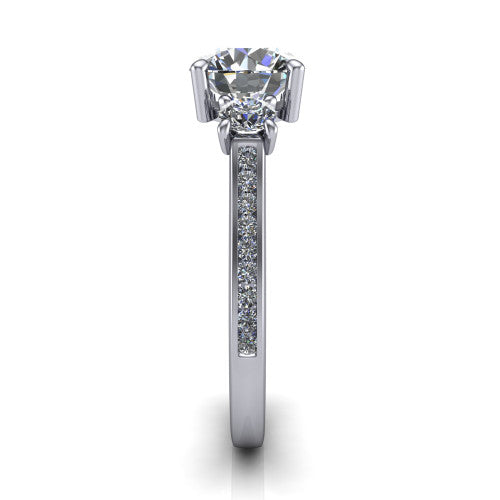 Saoirse round three stone engagement ring in Platinum, side profile showing the round side stone and the pav&eacute; diamonds running down the shank