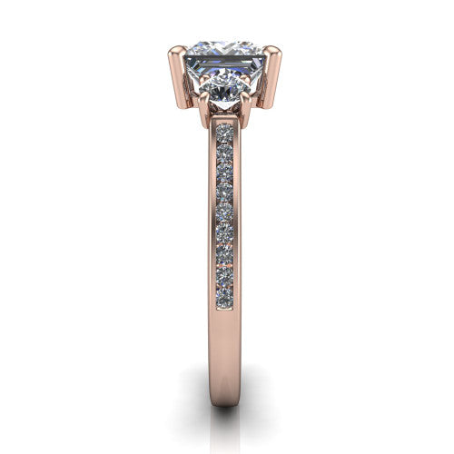 Saoirse princess three stone engagement ring in 14K Rose Gold, side profile showing the round side stone and the pav&eacute; diamonds running down the shank
