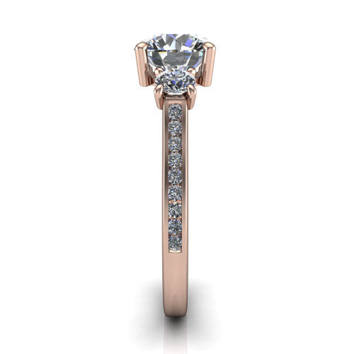 Saoirse round three stone engagement ring in 18K Rose Gold, side profile showing the round side stone and the pav&eacute; diamonds running down the shank