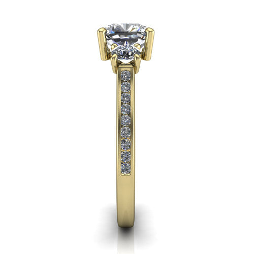 Saoirse cushion three stone engagement ring in 14K Yellow Gold, side profile showing the round side stone and the pav&eacute; diamonds running down the shank