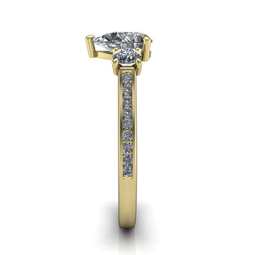 Saoirse pear three stone engagement ring in 18K Yellow Gold, side profile showing the round side stone and the pav&eacute; diamonds running down the shank
