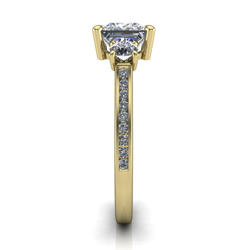 Saoirse princess three stone engagement ring in 14K Yellow Gold, side profile showing the round side stone and the pav&eacute; diamonds running down the shank